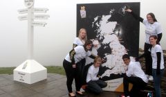 Ambassadors Mhairi Gifford from Shetland (top right corner), 18 year old Danielle Pryce from Aberystwyth, Wales; 14 year old Cassie Munro from Holywood, Belfast, Northern Ireland; 19 year old Sophie Lowe from Norwich, East of England; 14 year old Amy Johns from Penzance, Cornwall; and 14 year old Simran Dhingra-Smith from Newham, London point to their respective homes on the map during London 2012 Olympic Torch Relay Briefing - Photo by Matt Cardy