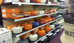 A shelf full of pots and pans in a store.