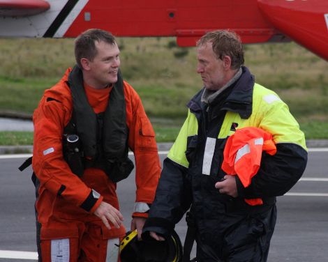 Shetland coastguard winchman Mark Hughes with one of the sailors. Pic. Garry Sandison