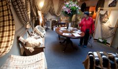 Maggie Skinner examines work at the Shetland Organics display at Vaila Fine Art, part of Wool Week. Pic. Billy Fox