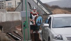 Last year's Northmavine jarl Ian Nicolson fills up at the new Hillswick pumps when they first opened a year ago. The birthday is being celebrated with the cheapest fuel in Shetland - Photo: Maree Hay, NCDC