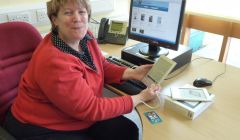 Librarian Marghie West tries out an eReader. Pic. SIC