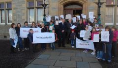 West side parents hand in a 1,048 signature petition to local member Theo Smith and council leader Gary Robinson ahead of Thursday's meeting. Pic. Shetland News