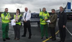 Shaking hands at Tingwall airstrip are (from left to right): Steve Munro, Air Area Service Manager, SAS; Julie Simpler, Director of Commercial, Directflight; Marshall Wishaw, Captain, Directflight; Peter Smith, Team Leader, SAS; Roger Diggle, Medical Director, NHS Shetland and Shetland MSP Tavish Scott - Photo: SAS