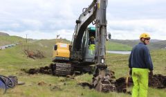 Workmen dig a hole for a new pole as part of the new Northmavine power line. Photo ShetNews