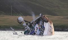 Prospect sinks on Monday night having been holed after running into the well-marked Skibby Baa in Lerwick harbour's north entrance. Photo Ian Leask