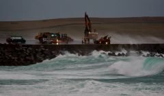 The scene at Sumburgh airport on Sunday morning as emergency services rescue the trapped digger driver. Photo Ronnie Robertson