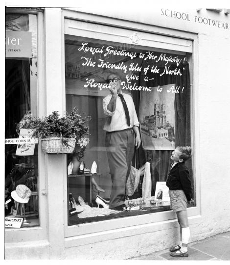 Attie Coutts signwriting in his shop window for the occasion of the Royal Visit in 1960 by Queen Elizabeth. Photo: Dennis Coutts
