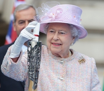 The Queen places her message in the Commonwealth Games baton before it set off on its world tour last October.