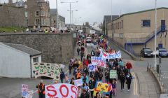 Demonstrators march through Lerwick last month to celebrate rural education and dissuade the SIC from their closure and other cost saving plans. Photo Shetnews