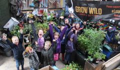 Kids from Urafirth primary school getting excited about Grow Wild at Hillswick, here on a rainy day with some of the plants for the native garden. Photo HWS