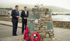 Cameron laying a wreath at the Shetland Bus memorial in Scalloway on Wednesday morning, as MP Alistair Carmichael looks on.