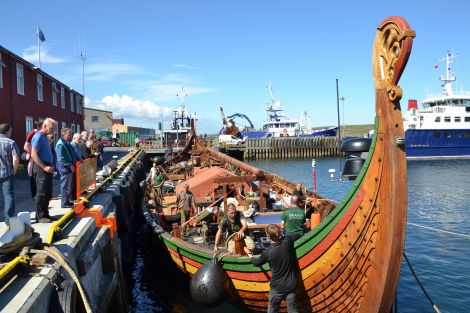 The crew of the Draken Harald enjoyed bright sunshine as they tidied up the longship on Monday. Photo: Shetnews/Neil Riddell