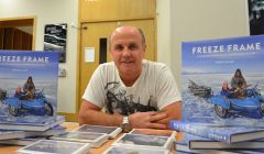 Wildlife photographer Doug Allan at Mareel with copies of his new book Freeze Frame. Photo Shetland News