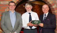 Former Shetland Recreational Trust chairman Joe Irvine (centre) receives a clock from general manager James Johnston this week, with new chairman Bryan Leask. Photo SRT