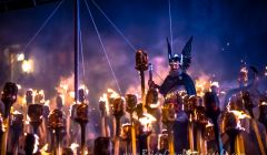 Guizer Jarl Olav Haraldsson cuts a spectacular figure as the torches give the night air a beautiful hue. Photo: Brian Gray