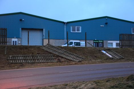 Fencing blown over outside Tulloch Developments' premises at Gremista in Lerwick. Photo: Mark Berry