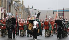 The Jarl's Squad, led by Neil Robertson, heading in over along Commercial Road in dreich conditions. Photo: Geoff Leask