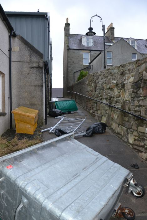 Wheelie bins on their side in Lerwick's Pitt Lane. Photo: Shetnews