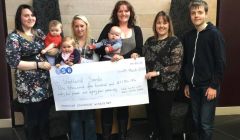 Marie Manson of Shetland Sands (right with her son William) is accepting the donation from Nicola Bowie with Rylee, Amy Gerrard with Lucy and Jennifer Munro with Magnus.
