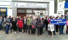 Protesters gather outside Alistair Carmichael's constituency office on Saturday afternoon to call for his resignation. Photo Shetnews