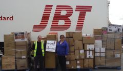 Julie Odie pictured with JBT's Tony Monaghan and the parcels bound for Moldova.