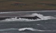 The eastern end of the Sumburgh airport runway extension being battered by heavy seas two years ago. Photo Ronnie Robertson