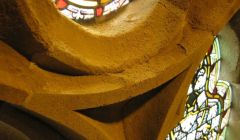 Crumbling sandstone around one of the main hall's many prestigious stained glass windows.