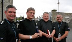 Special occasion. Shetland area commander Lindsay Tulloch (left) with retiring Barry Derbyshire and Peter Smith holding their medals with assistant chief constable Derek Robertson.