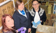 Collections curator Jenny Murray (right) and her assistant Laurie Goodlad (left) show NorthLink's Cheryl Kelday the artefacts. Photo Shetland Amenity Trust