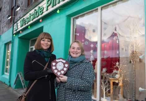 Marina Hunter of Westside Pine receiving the award from Living Lerwick's Cynthia Adamson.