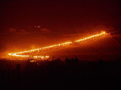 460 torch wielding guiders follow the SMUHA galley down to the Peerie Spiggie beach on Friday night for the burning. Photo Chris Brown