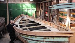 Shetland museum curator Ian Tait with the restored Oceanic lifeboat, now just in need of a lick of paint - Photo: Hans J Marter/ShetNews