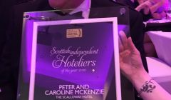 Peter Mackenzie holds up the award he and his wife Caroline won on Sunday night.
