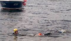 Surrounded by small boats two of the swimmers on their way to Whalsay - Photo: Jeni Polson