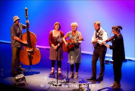 From left: bassist Graham Malcolmson, singers Sheila Duncan and Freda Leask, mandolinist Lewie Peterson and fiddler Lois Nicol around a single mic at Mareel on Saturday evening. Photo: Dale Smith