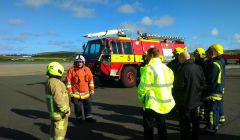 Andrew Dane meeting the fire crew at Sumburgh Airport on his visit to Shetland.