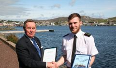 Ross Sinclair receiving his award from Captain George Sutherland.