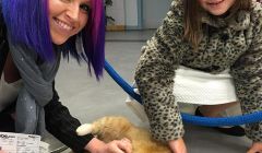 Katrina Williamson and her daughter Layla getting acquainted with Tigger while waiting for a flight.