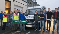 David Grieve of Shetland Foodbank and Tesco store manager Neil Connell (centre) with local volunteers from Inside Connections, Lerwick Celtic, Lerwick Community Council and Islesburgh Drama Group at the St Magnus Street foodbank on Monday.