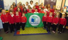 Pupils at Cullivoe Primary School celebrate achieving their third eco flag. Photo courtesy of Shetland Islands Council.