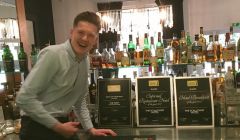 Delighted duty manager Jonny Sandison proudly displaying Scalloway Hotel's three awards.