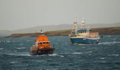 Crab boat Edward Henry heading back to the safety of the port alongside the Aith lifeboat. Photo: Leslie Tulloch
