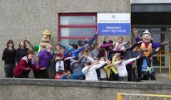 Ivor Goodsite and Honor Goodsite with pupils and staff at Baltasound Junior High School practicing Usian Bolt style celebrations. Photo: Morrison Construction