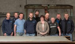 Cooke Aquaculture employees gather at the boat building yard to mark the occasion of the keel laying. From left to right: Tommy Ridland, Eric MacMillan, Ian Anderson, Jahn-Remi Hatledal, David Brown, Katrine Johnson, Dennis Johnson, John Wilson, Ewan Georgeson and Keith Leslie. Photos: Ivan Hawick