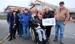 John Hunter, Chair of Shetland Special Needs Action Group (right), presents a cheque for £10,000 to Connie Russell, Team Leader – Eric Gray Resource Centre, towards the Hansel Fund for the new building. Back row (l to r) – Chris Pulley, Neil Risk, Kenny Groat, Davy Napier, Thelma Leslie. Front row: Janne Glesnes Martin (EGRC), Katie Hunter, Paul Ditchburn, May MacDonald, Doreen Williamson, Connie Russell and John Hunter. Centre Front – Dylan McDougal. Photo: SIC