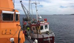 The creel boat Sadie Joan being taken under tow by the Lerwick lifeboat.