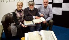 Looking through the minutes are (left to right): former Althing chairwoman Florence Grains, Shetland archivist Brian Smith and current Althing chairman Andrew Halcrow. Photo: Hans J Marter/Shetland News