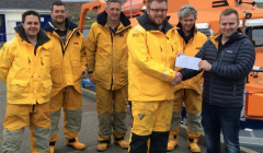 Captain Marius Joensen presenting the cheque to crew member John Robertson. Also pictured, left to right, are Allan Willmore, Chris Smith, David Nicolson and Luke Bullough. Missing from picture are Lewis Fraser and Pete Hanscombe. Photo: RNLI/Liz Boxwell