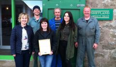 Sita Goudie with the award, flanked by Shetland Amenity Trust staff.